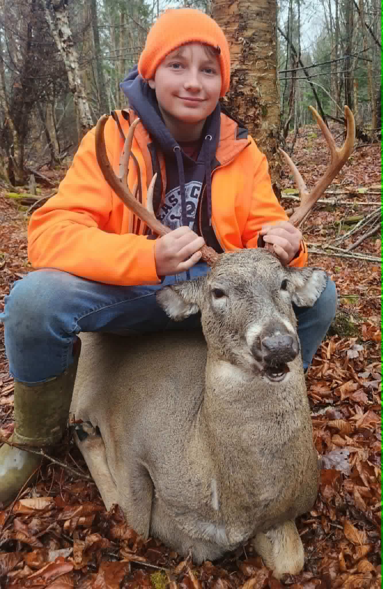 Young hunter with a whitetail buck