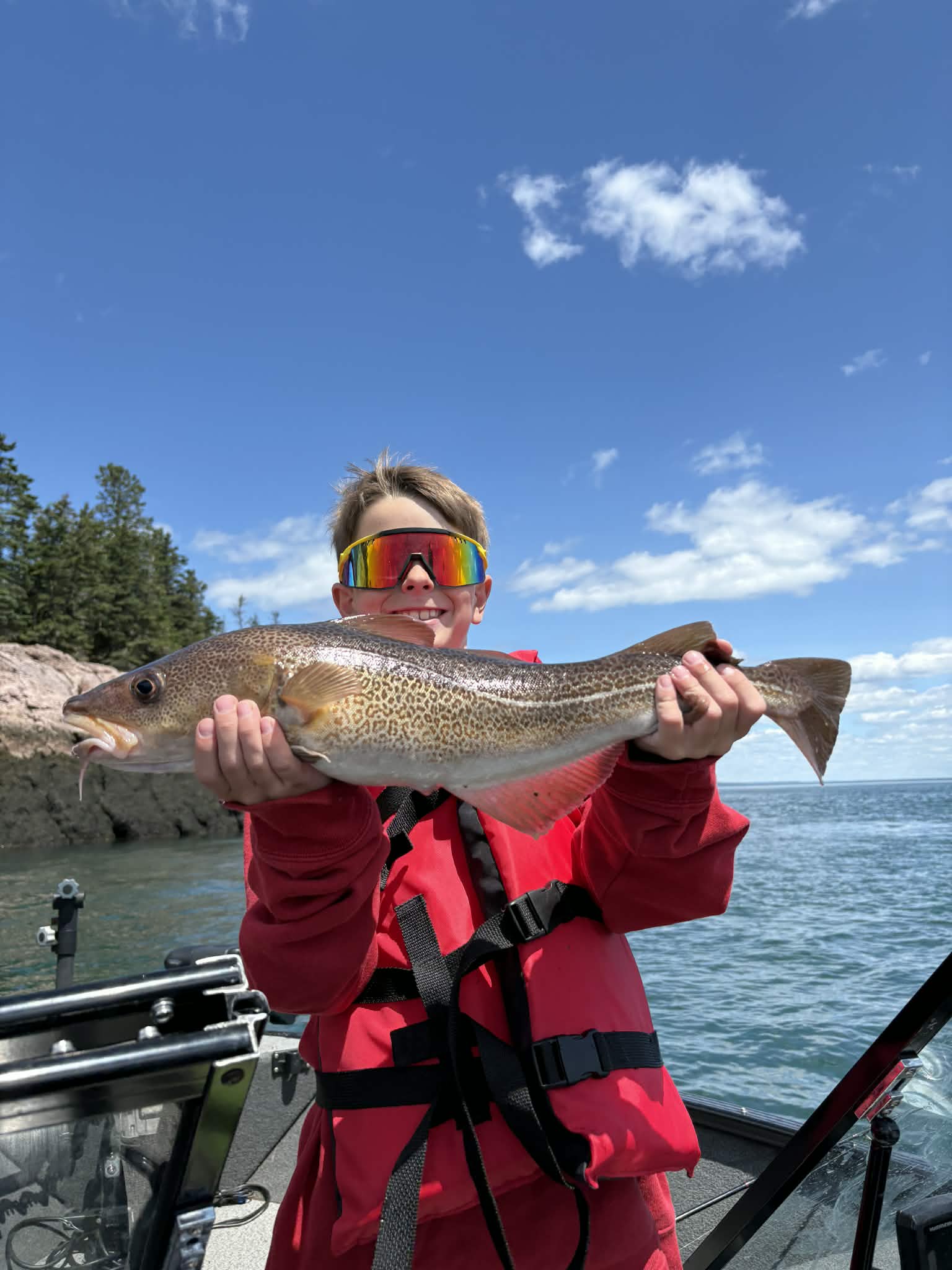 Young angler holding a large cod