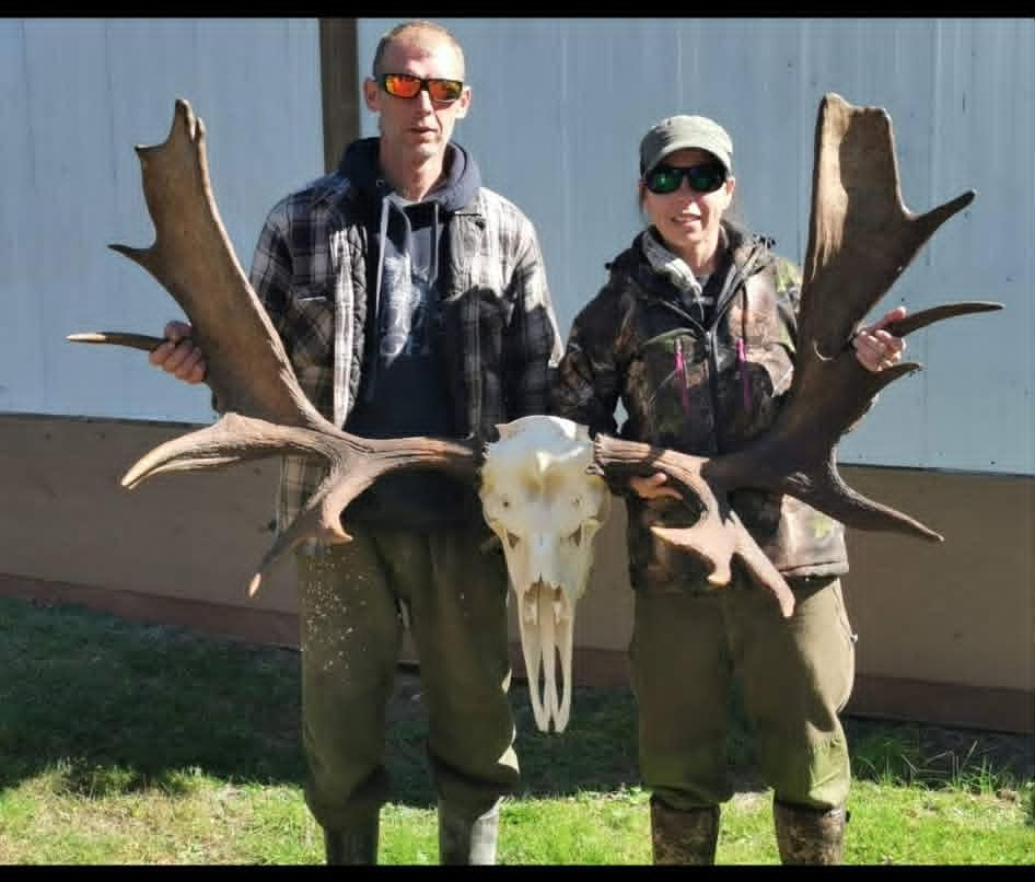 Hunters with a moose antler mount