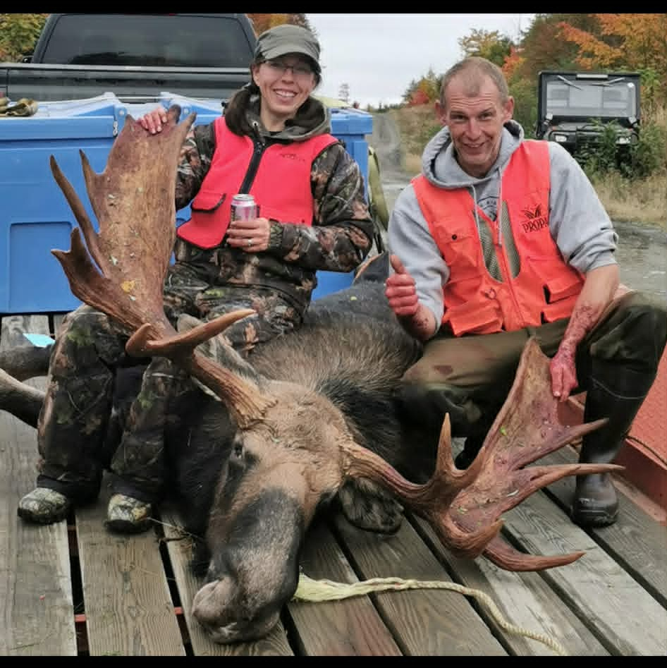 Hunters with a harvested moose