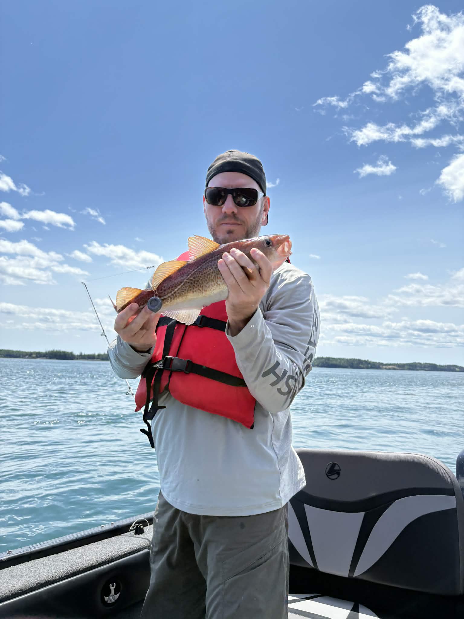 Angler holding a cod catch