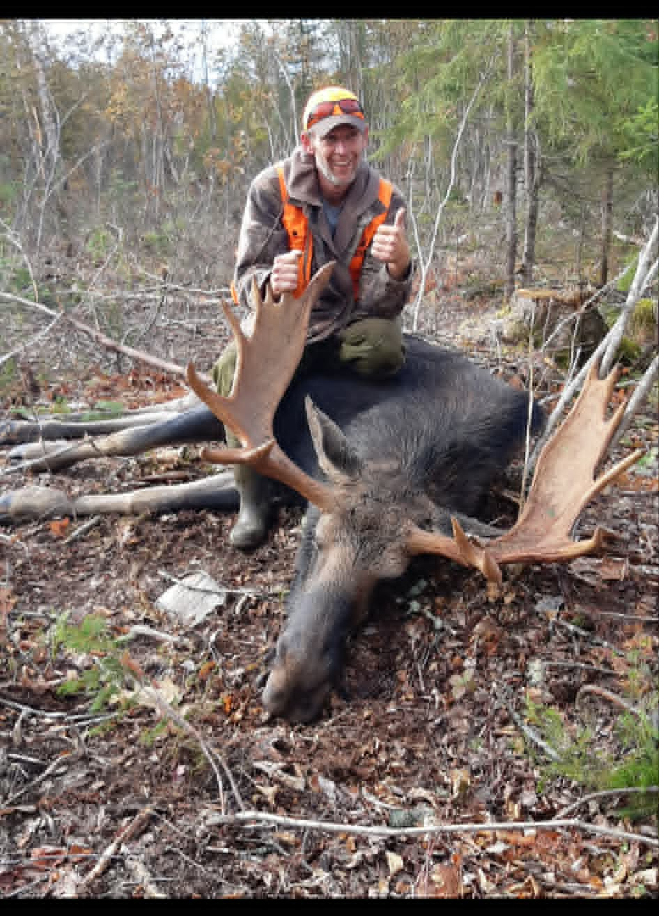 Hunter with a harvested moose