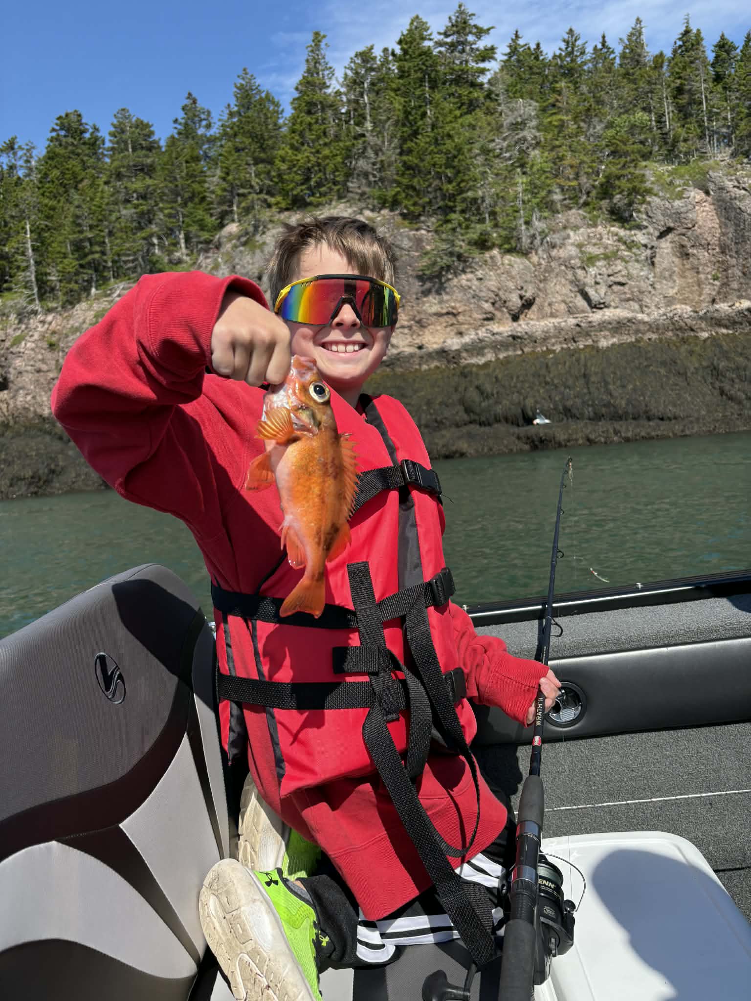 Young angler holding a small redfish