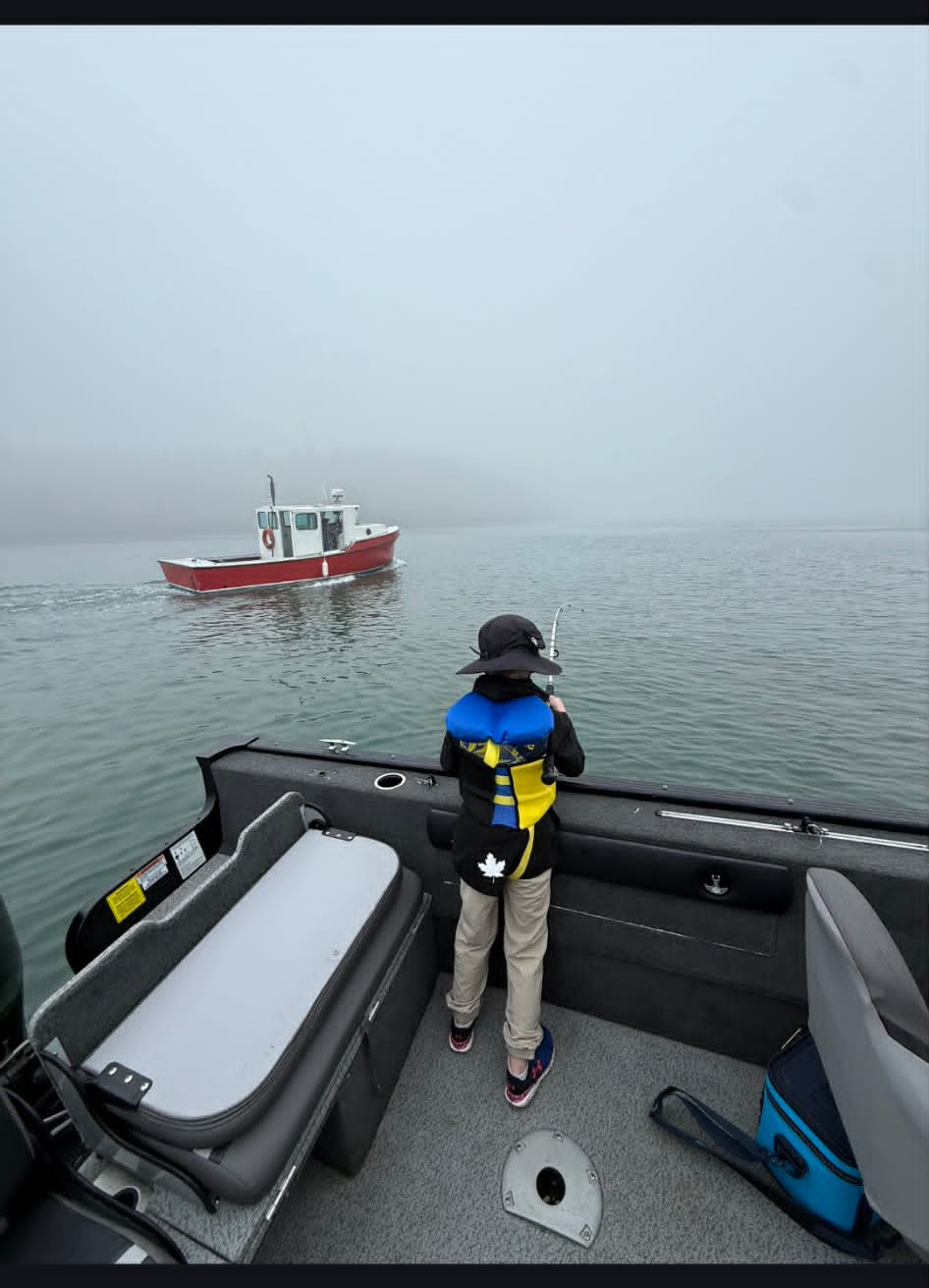 Young angler fishing on a foggy saltwater morning